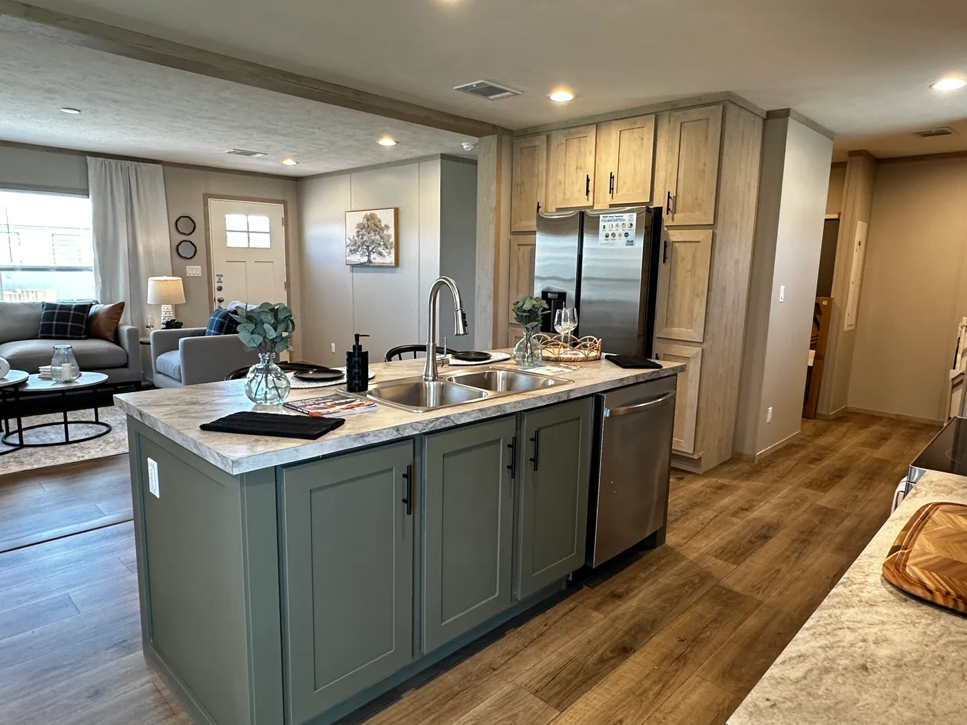 Spacious 3 bedroom, 2 bathroom double wide manufactured home built for comfort and family living. This open layout features both a living room and separate den, perfect for movie nights, entertaining, or creating private space for kids and adults. The modern kitchen includes stainless steel appliances and ample cabinet space. Enjoy year-round comfort with energy-efficient upflow ceiling vents for improved airflow. The private primary suite offers a relaxing retreat with a large soaking tub and s