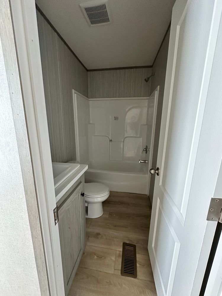 2nd bathroom with fiberglass tub shower combo.  Upgraded ceramic sink.  