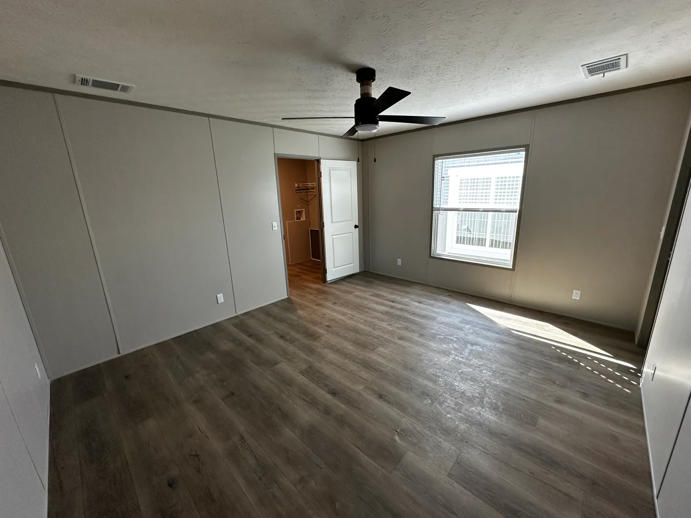 Discover this luxury porch model manufactured home featuring 2 bedrooms, 2 bathrooms, and high-end finishes designed for comfort and style. This modern manufactured home offers an open floor plan, stainless steel appliances, and a huge kitchen island perfect for entertaining. The spacious suite includes a walk-in closet and a large tiled low-profile walk-in shower for a spa-like feel. Built for durability and long-term value, this home features SmartPanel siding with a 50-year warranty, a 25-yea