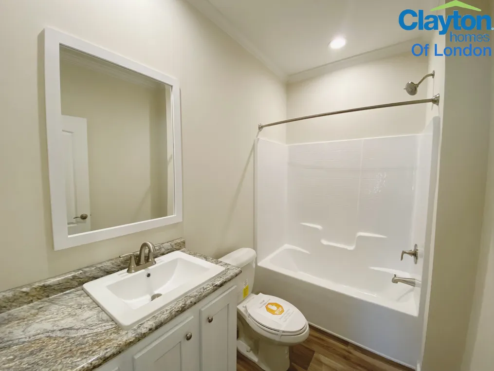 Porcelain sink. Stand up shower/tub combo.