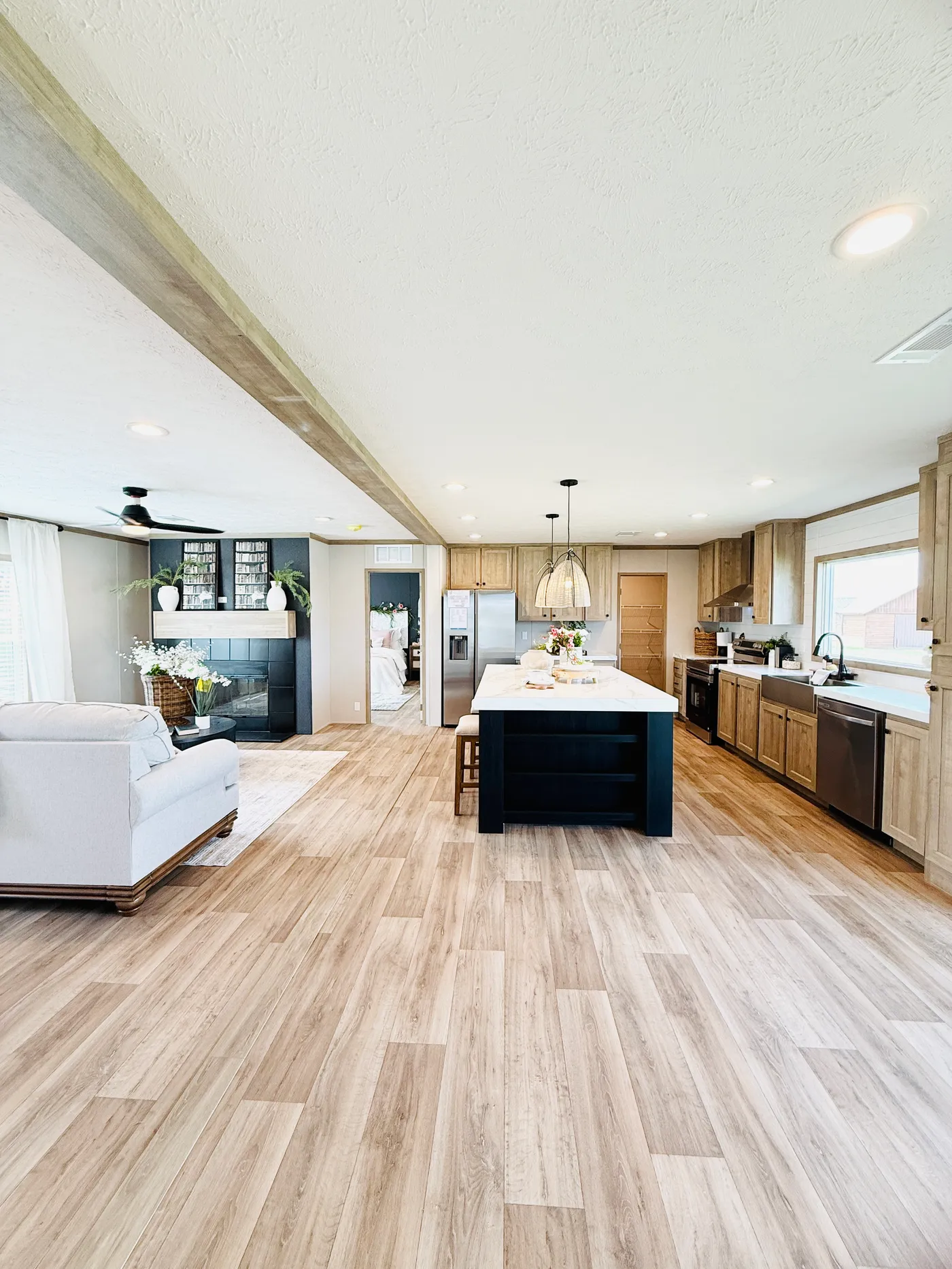 This stunning open-concept kitchen features a large center island, modern lighting, and plenty of cabinet space, making it perfect for preparing meals or entertaining guests.

The layout flows beautifully into the living area so you can stay connected with family and friends while cooking.
