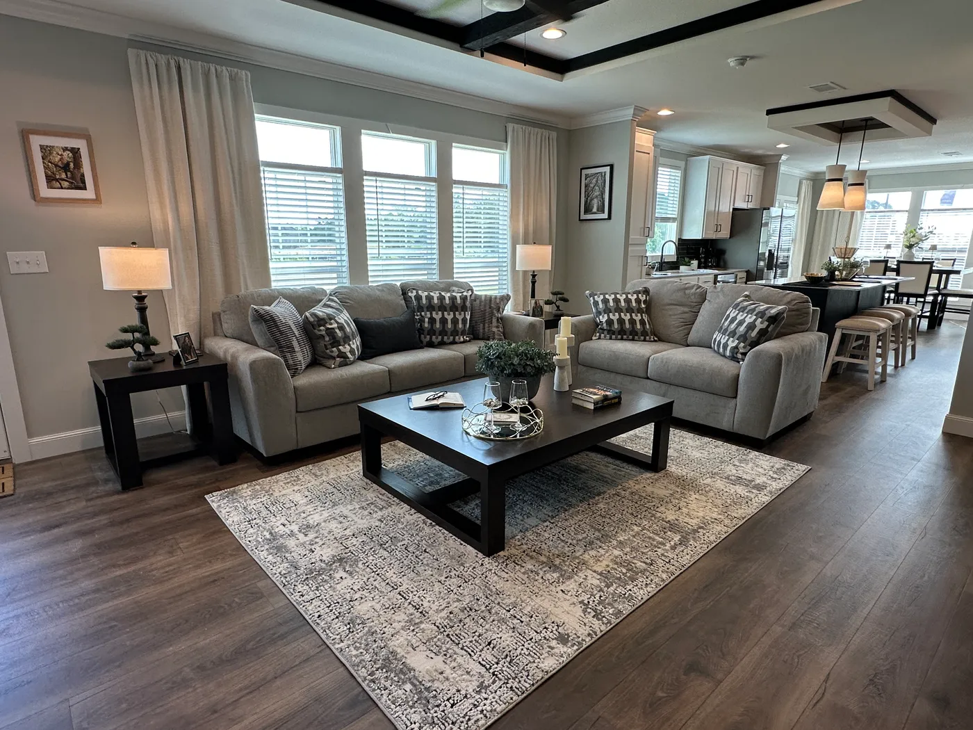 Step inside one of the most beautiful 4 bedroom, 3 bathroom tape and textured doublewide manufactured homes on the market. This stunning home is designed with upscale finishes, open living space, and modern comfort throughout. The spacious living room features vaulted ceilings, elegant crown moulding, and a built-in fireplace that creates a warm, high-end feel the moment you walk in.

The kitchen is loaded with premium features, including quartz countertops, stainless steel appliances, and a s