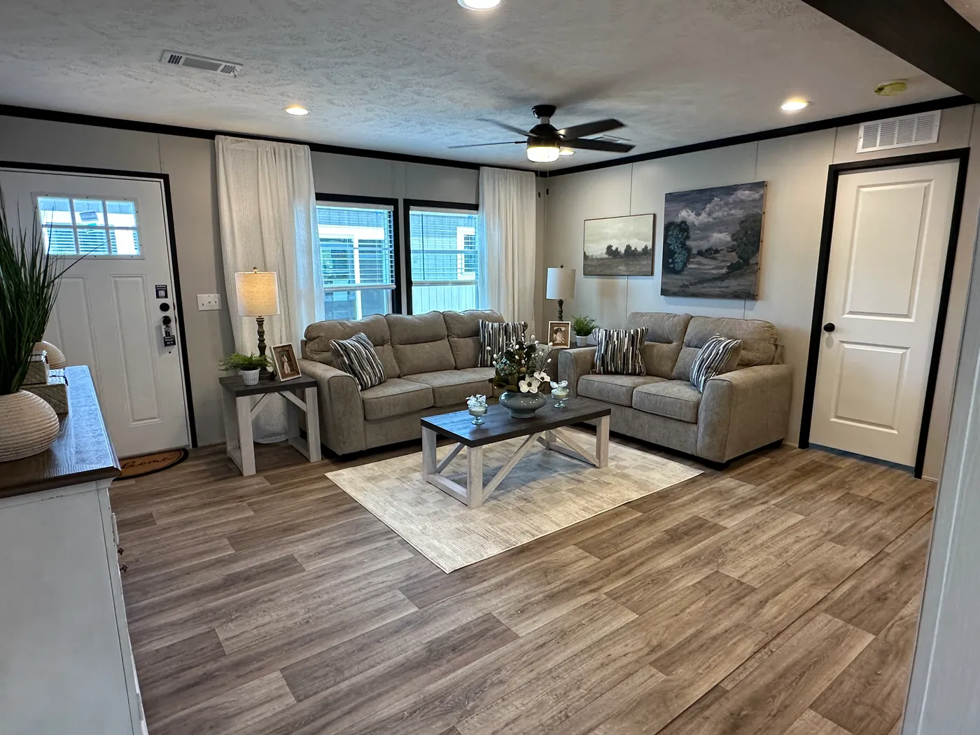 Discover The Heritage, a beautiful 3-bedroom, 2-bath manufactured home offering 1,568 square feet of spacious, functional living at Clayton Homes of Alvin, Texas! This stunning home features a spacious open-concept living room, a modern kitchen with an oversized multifunctional island, and a beautiful built-in fireplace. Enjoy a thoughtfully designed private split-bedroom floor plan, offering comfort and separation for the entire family. The oversized utility and laundry room features a convenie