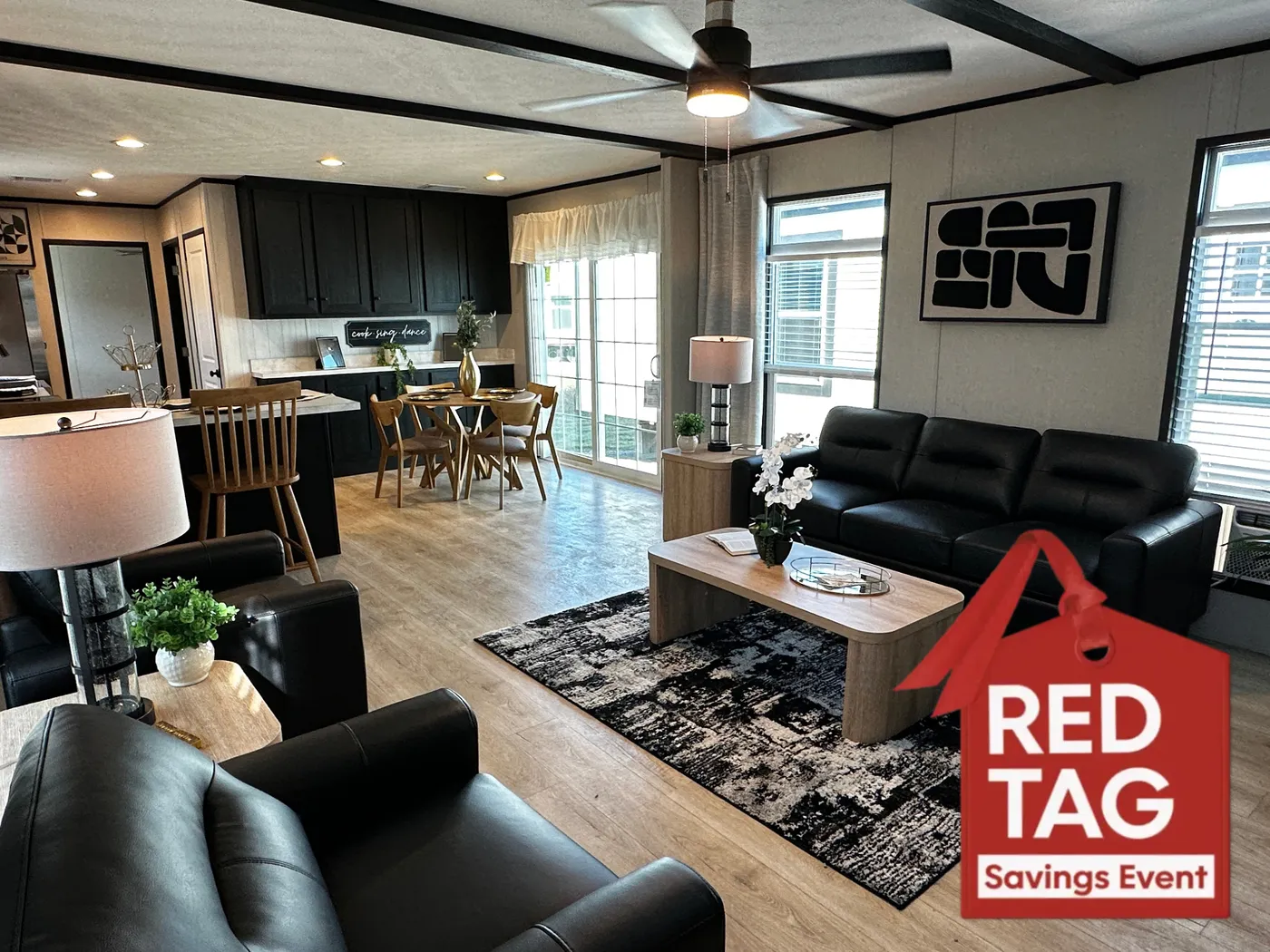 Beautiful 3 bedroom, 2 bathroom manufactured home featuring a modern charcoal interior and open-concept design. The stylish kitchen includes stainless steel appliances, a stainless steel farmhouse sink, and ample cabinet space. The spacious living room offers a built-in entertainment center with electric fireplace, perfect for relaxing or entertaining. The private primary suite features a tiled low-profile walk-in shower, a large garden soaking tub, and generous storage. This home combines affor