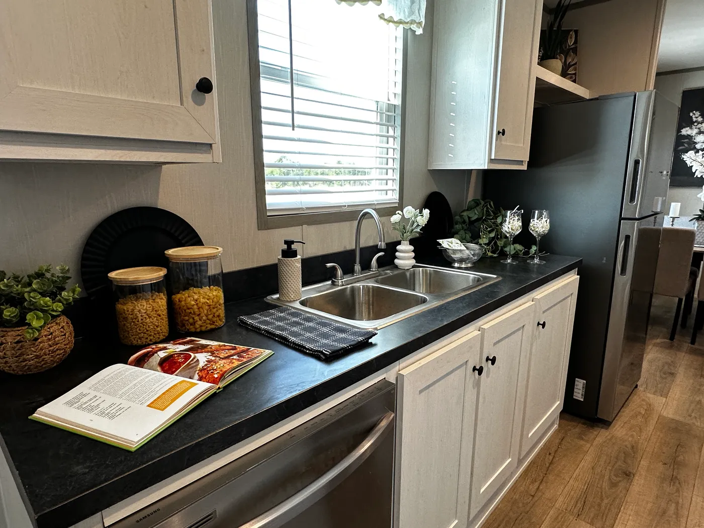 Affordable luxury meets modern comfort in this 3 bedroom, 2 bathroom manufactured home designed for spacious living and energy efficiency. The open-concept layout features a stylish kitchen with stainless steel appliances and a large walk-in pantry for extra storage. The private primary suite includes a generous walk-in closet and a relaxing retreat feel. Enjoy improved comfort with ceiling air vents for better airflow and temperature control throughout the home. This energy-efficient home offer