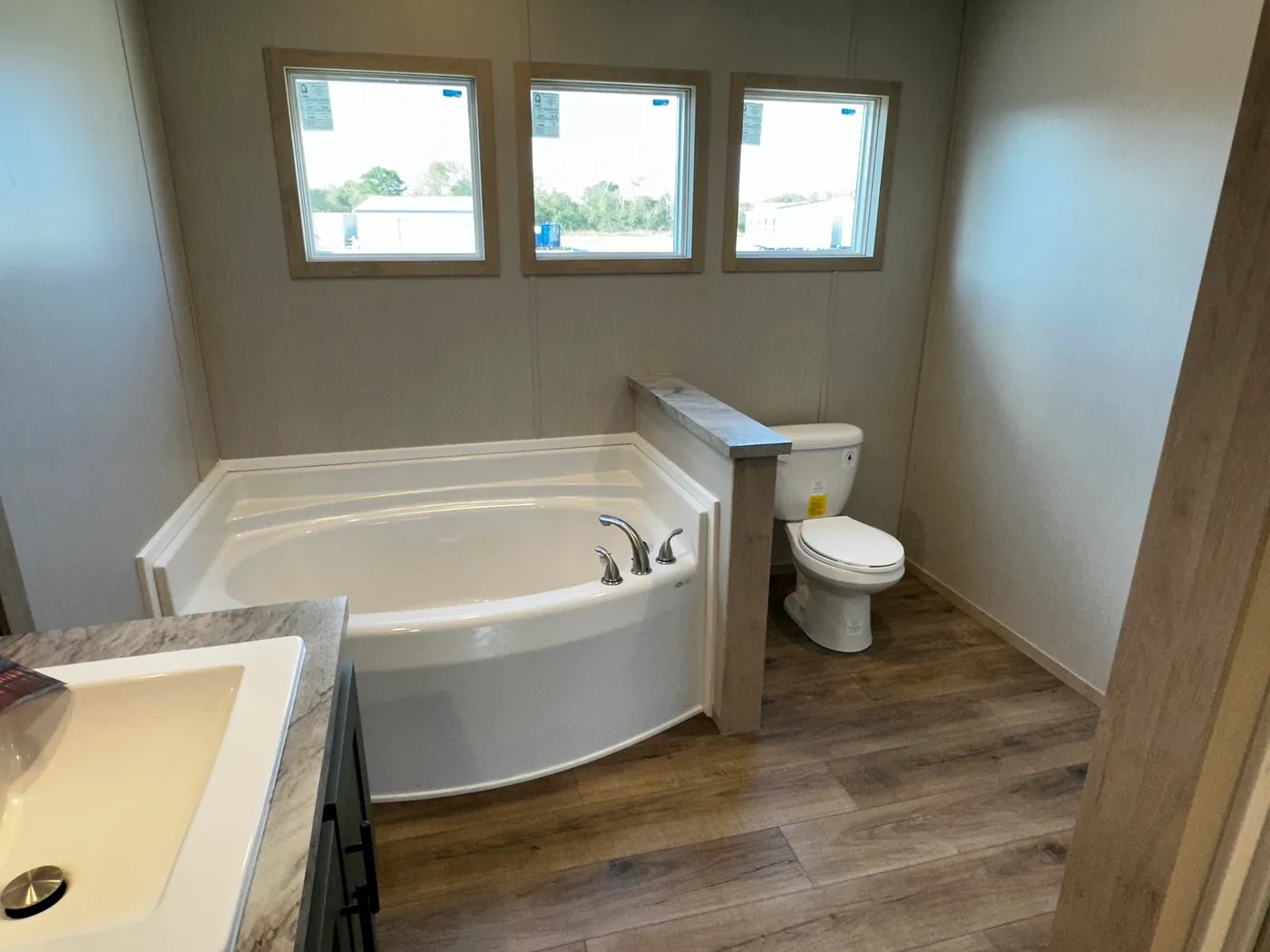 Spacious 3 bedroom, 2 bathroom double wide manufactured home built for comfort and family living. This open layout features both a living room and separate den, perfect for movie nights, entertaining, or creating private space for kids and adults. The modern kitchen includes stainless steel appliances and ample cabinet space. Enjoy year-round comfort with energy-efficient upflow ceiling vents for improved airflow. The private primary suite offers a relaxing retreat with a large soaking tub and s