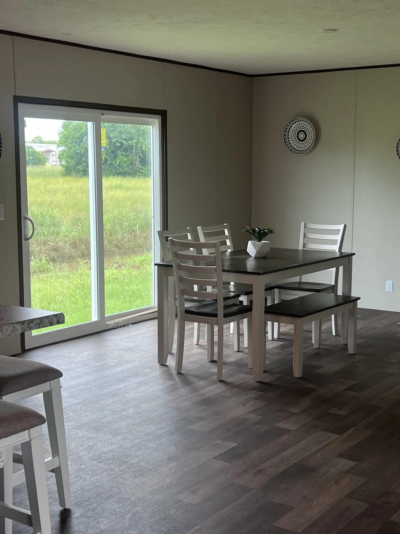 The dining room is a bright inviting space with patio doors that lead directly to the outdoor area, perfect for indoor-outdoor dining or activities. the layout is open and airy, making it an ideal spot for family meals and entertaining