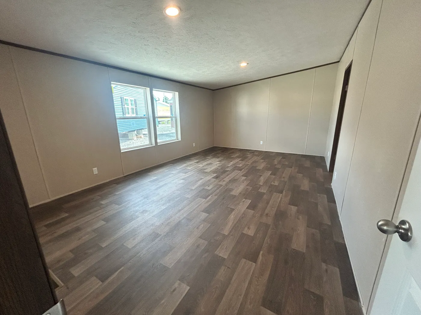 Side by side windows in the main bedroom let in plenty of natural lighting. 