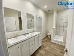 Double Vanity. Large tile shower.