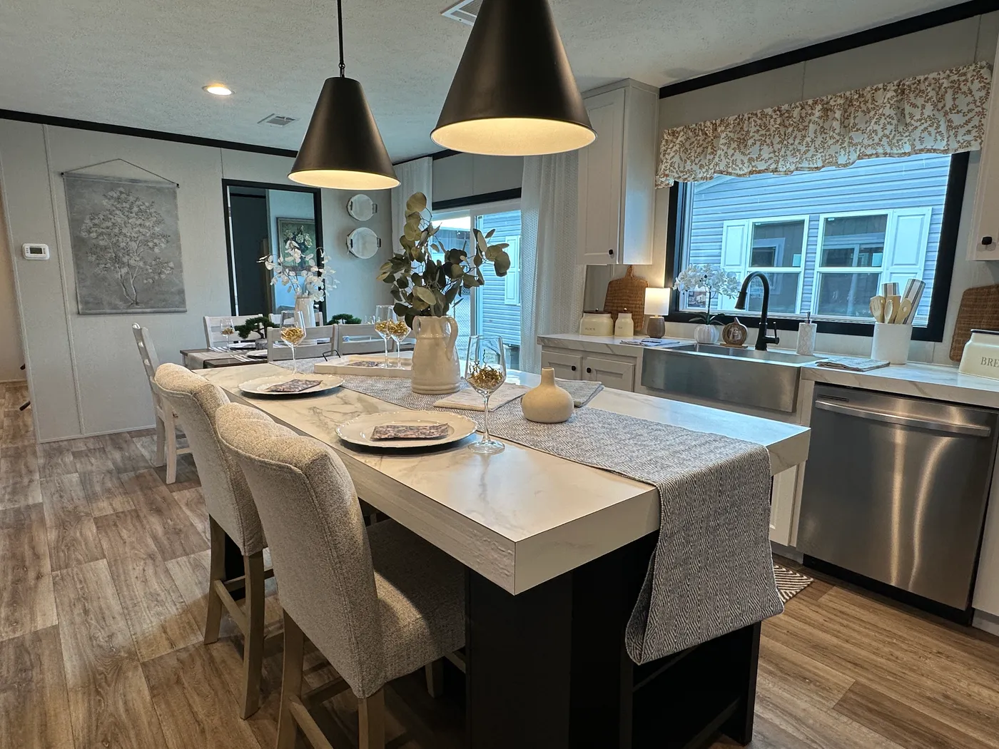 Discover The Heritage, a beautiful 3-bedroom, 2-bath manufactured home offering 1,568 square feet of spacious, functional living at Clayton Homes of Alvin, Texas! This stunning home features a spacious open-concept living room, a modern kitchen with an oversized multifunctional island, and a beautiful built-in fireplace. Enjoy a thoughtfully designed private split-bedroom floor plan, offering comfort and separation for the entire family. The oversized utility and laundry room features a convenie