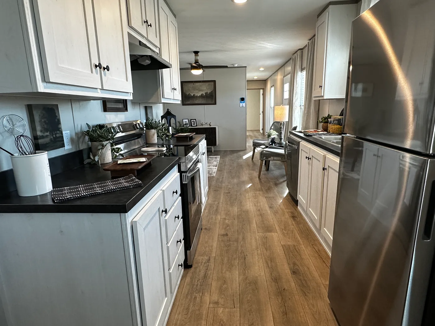 Affordable luxury meets modern comfort in this 3 bedroom, 2 bathroom manufactured home designed for spacious living and energy efficiency. The open-concept layout features a stylish kitchen with stainless steel appliances and a large walk-in pantry for extra storage. The private primary suite includes a generous walk-in closet and a relaxing retreat feel. Enjoy improved comfort with ceiling air vents for better airflow and temperature control throughout the home. This energy-efficient home offer