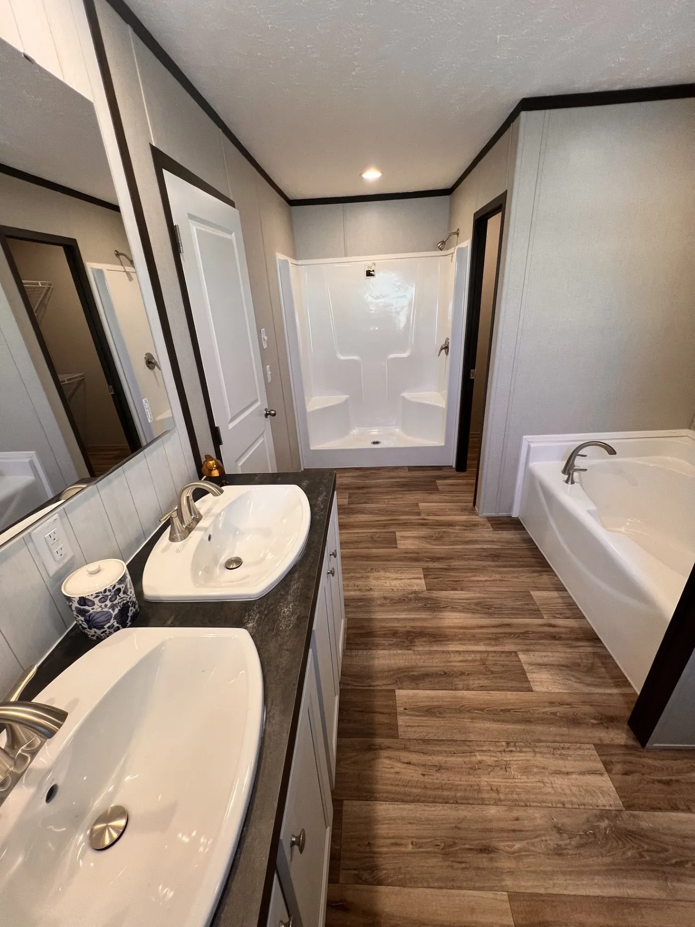 Spacious primary bathroom featuring a double sink vanity, large soaking tub, and separate walk-in shower with built-in seating. Plenty of room for both everyday routines and relaxing at the end of the day.
