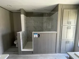 Spacious 72” tile shower and storage in the primary bathroom