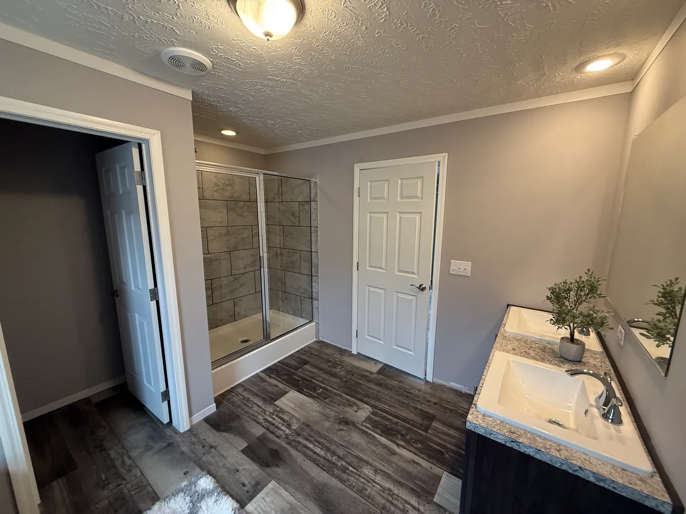 Backside view of primary bathroom showing ceramic shower