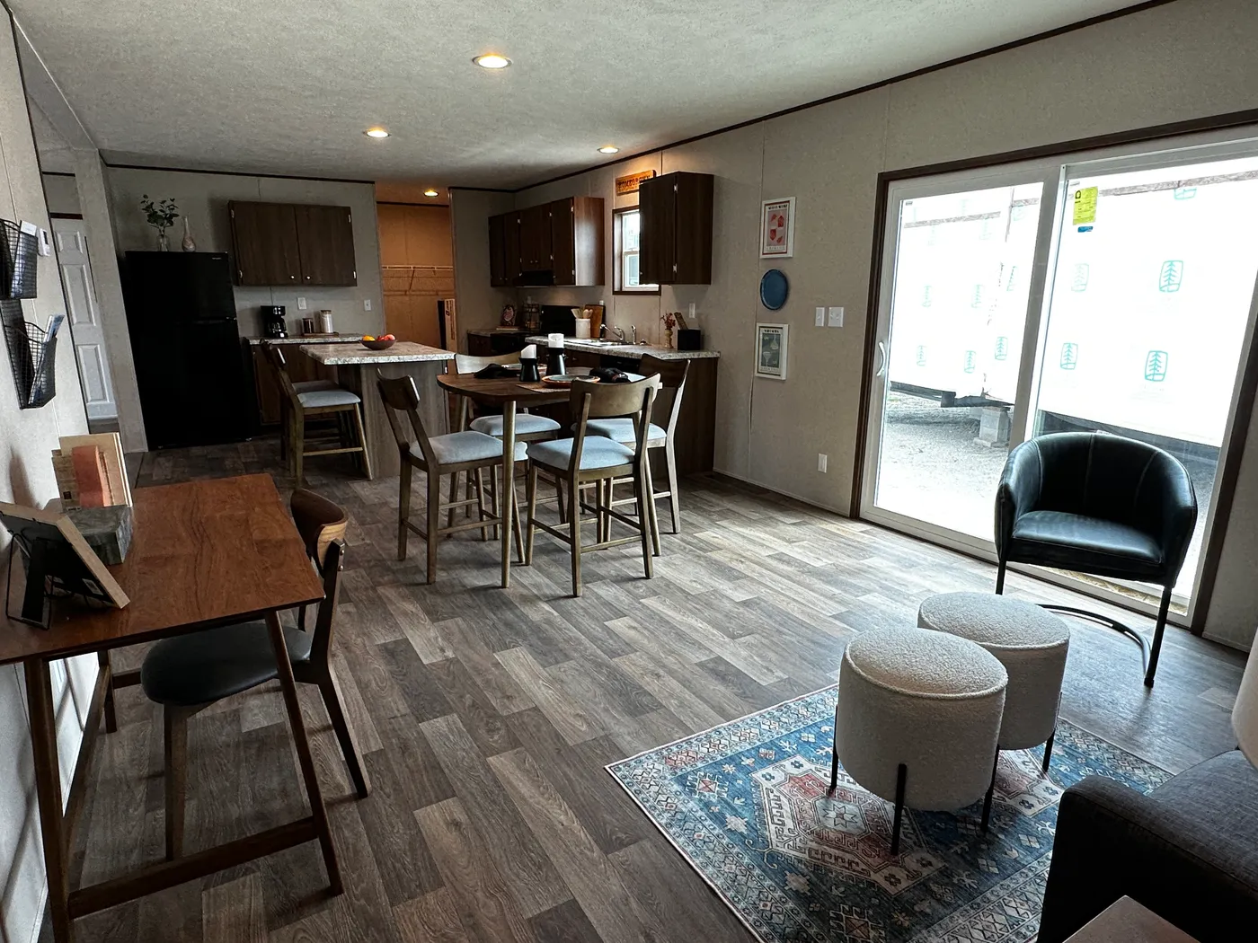 Discover the most affordable and spacious 4 bedroom, 2 bath doublewide manufactured home on the market! This budget-friendly mobile home features elevated ceilings, an open-concept layout, and plenty of room to grow with both a living room and separate den—perfect for entertaining, relaxing, or family space. The modern kitchen includes a large center island with ample storage and workspace. The private primary suite offers a walk-in closet, plus a luxury separate soaking tub and walk-in shower f