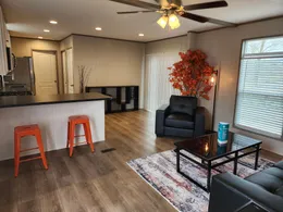 Open concept living room and kitchen with space for a dining table by the sliding glass door