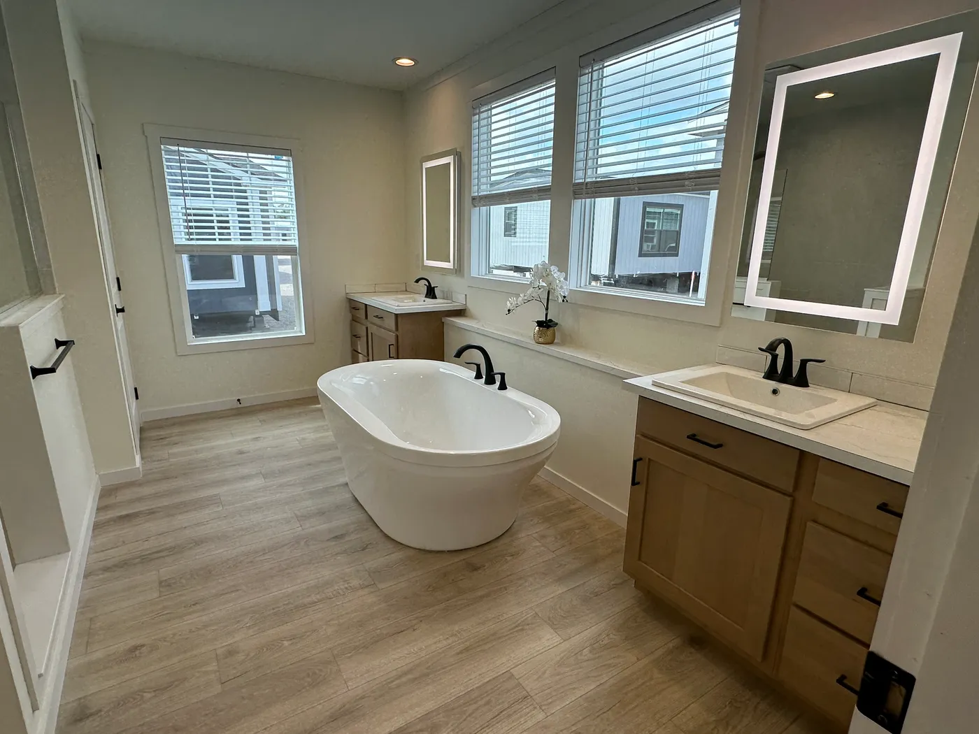 Discover The Cambridge, a stunning 3-bedroom, 2-bath luxury manufactured home at Clayton Homes of Alvin, Texas! This beautiful home features tape-and-textured walls, elegant crown molding, gorgeous quartz countertops, and a Samsung Smart Refrigerator. The gourmet kitchen includes a hidden walk-in Butler’s pantry with extra shelving and a second refrigerator for exceptional storage. The luxurious primary bedroom showcases a beautiful illuminated accent wall, while the spa-inspired primary bathroo
