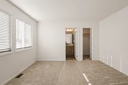 Primary bedroom with walk-in closet & private bathroom