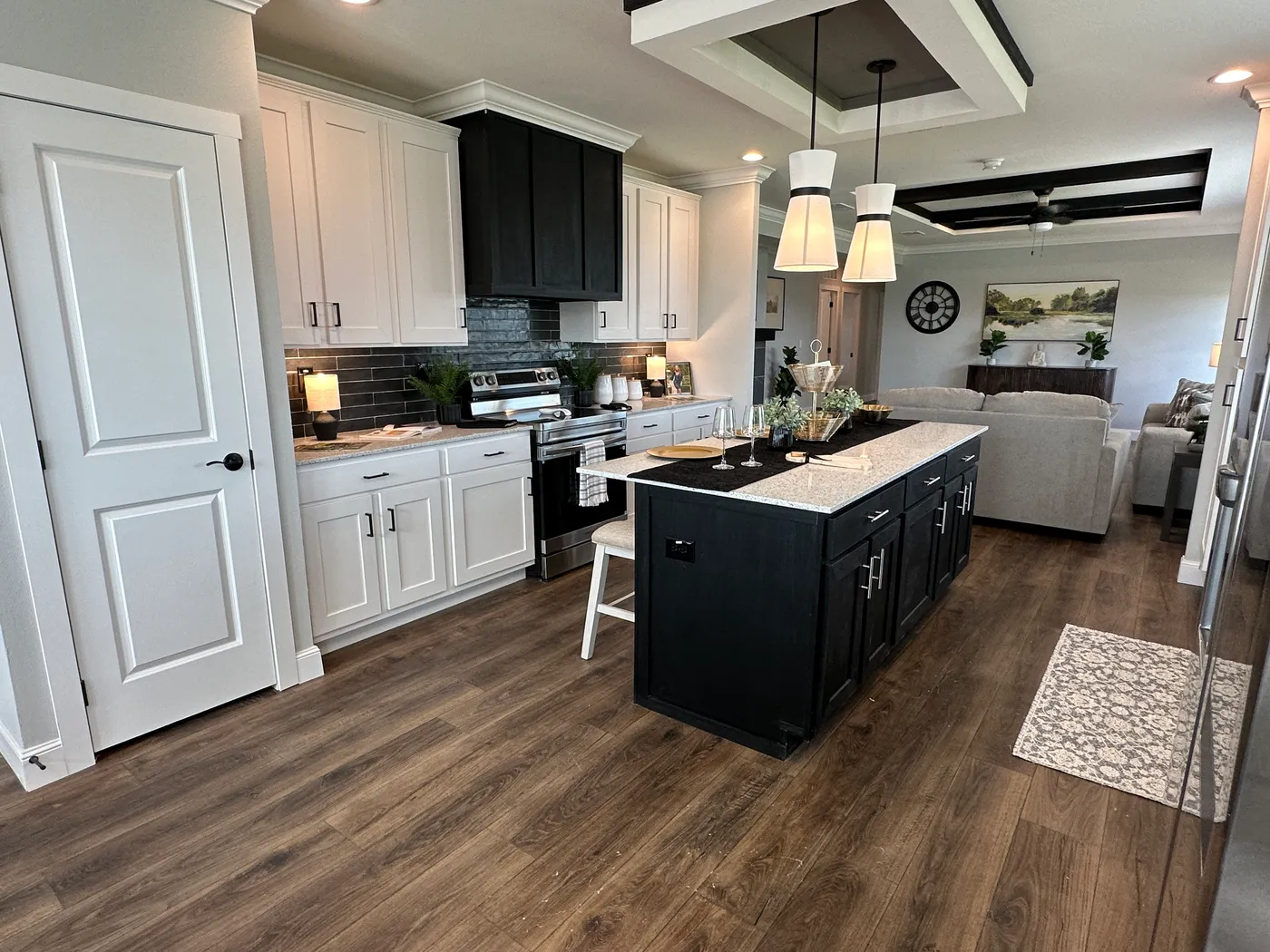 Step inside one of the most beautiful 4 bedroom, 3 bathroom tape and textured doublewide manufactured homes on the market. This stunning home is designed with upscale finishes, open living space, and modern comfort throughout. The spacious living room features vaulted ceilings, elegant crown moulding, and a built-in fireplace that creates a warm, high-end feel the moment you walk in.

The kitchen is loaded with premium features, including quartz countertops, stainless steel appliances, and a s