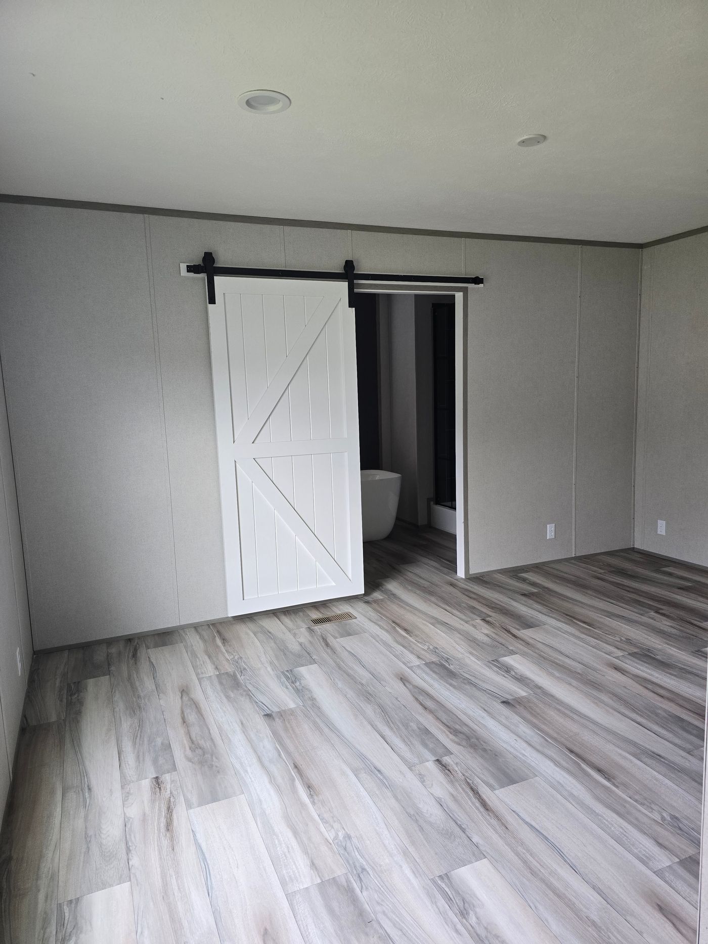 Sliding barn door entry into primary ensuite