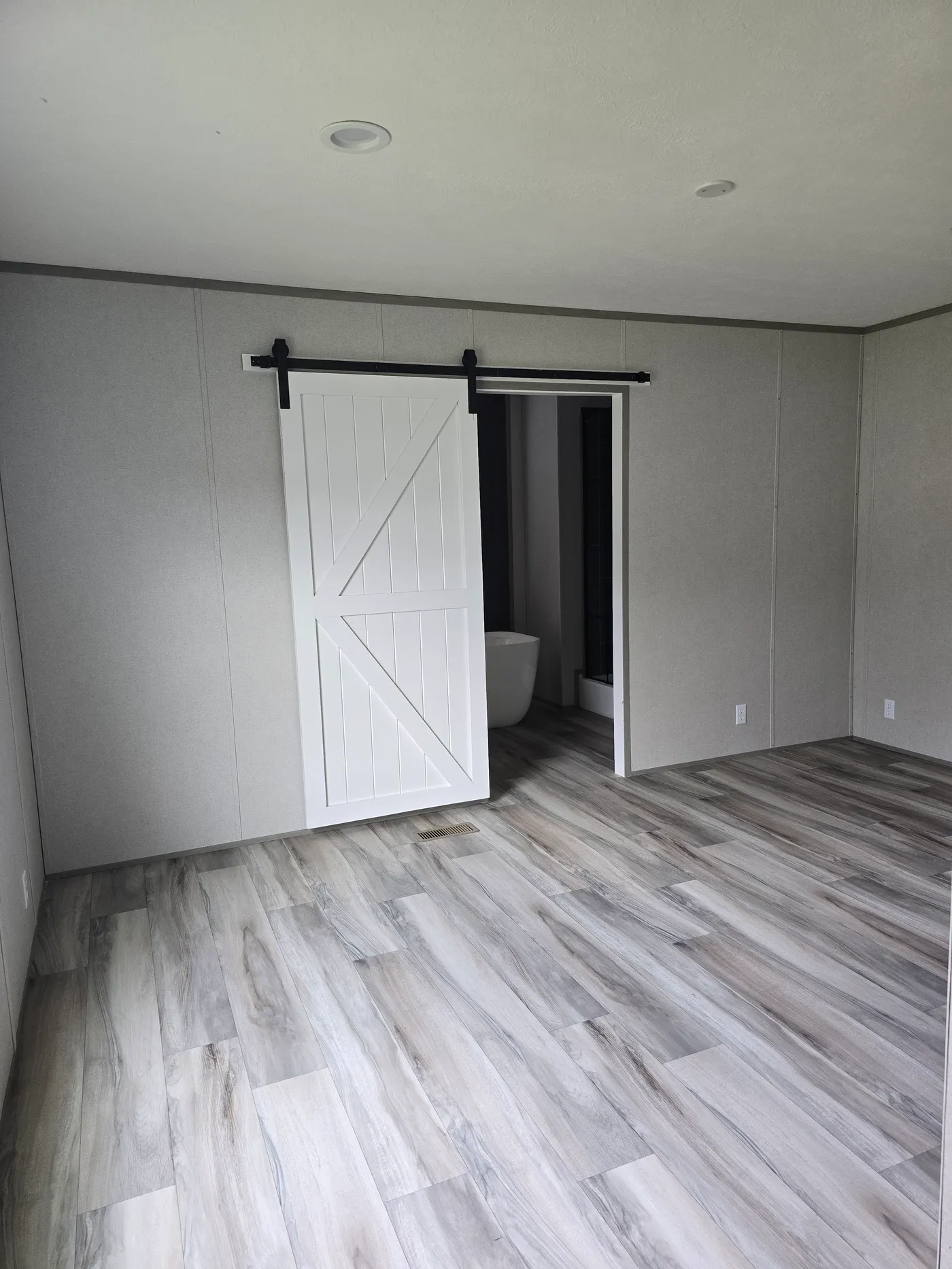 Sliding barn door entry into primary ensuite