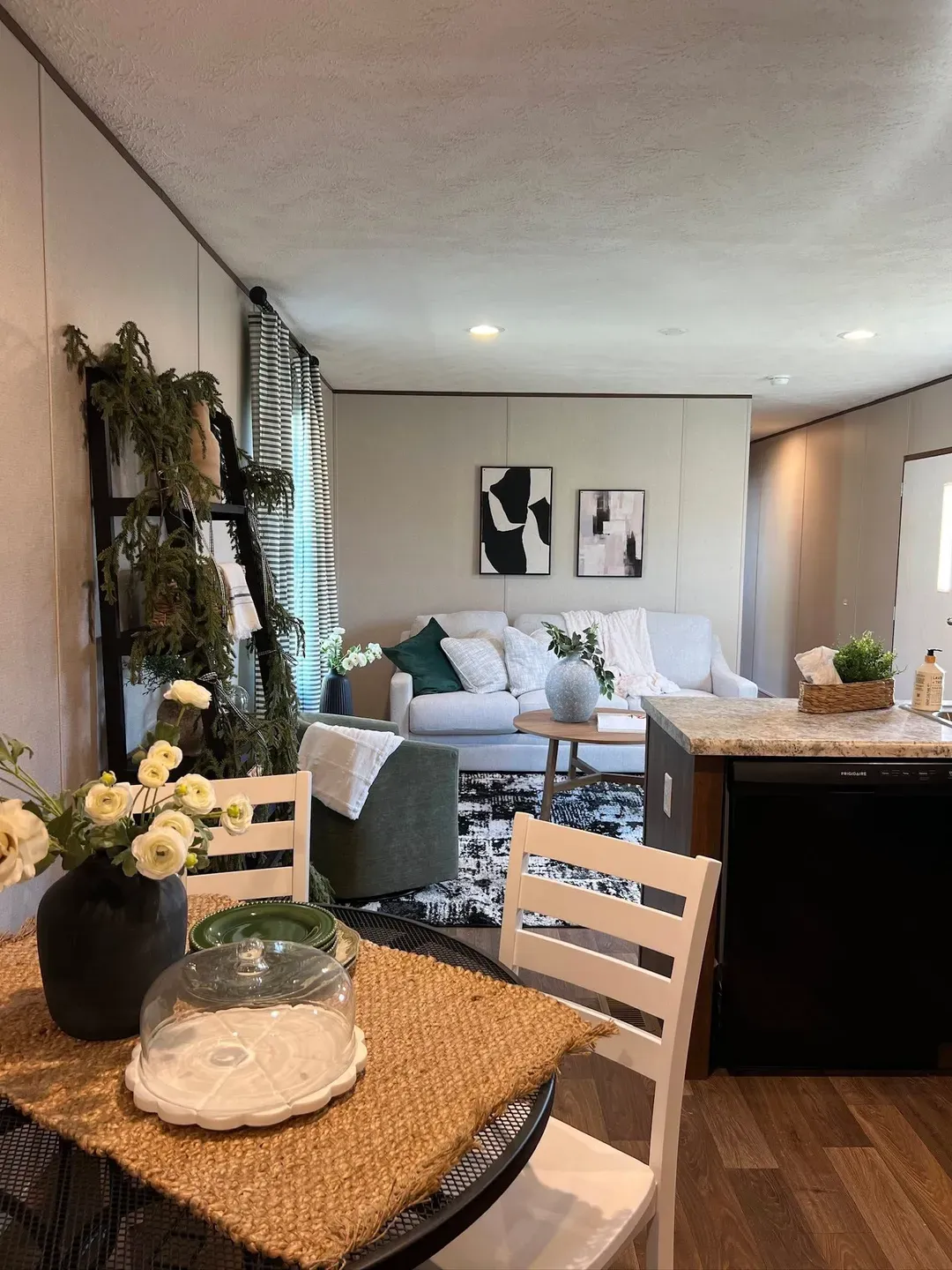 This open-concept living space blends warm textures, natural tones, and smart design to create a beautifully inviting place to relax, gather, and feel right at home. ??