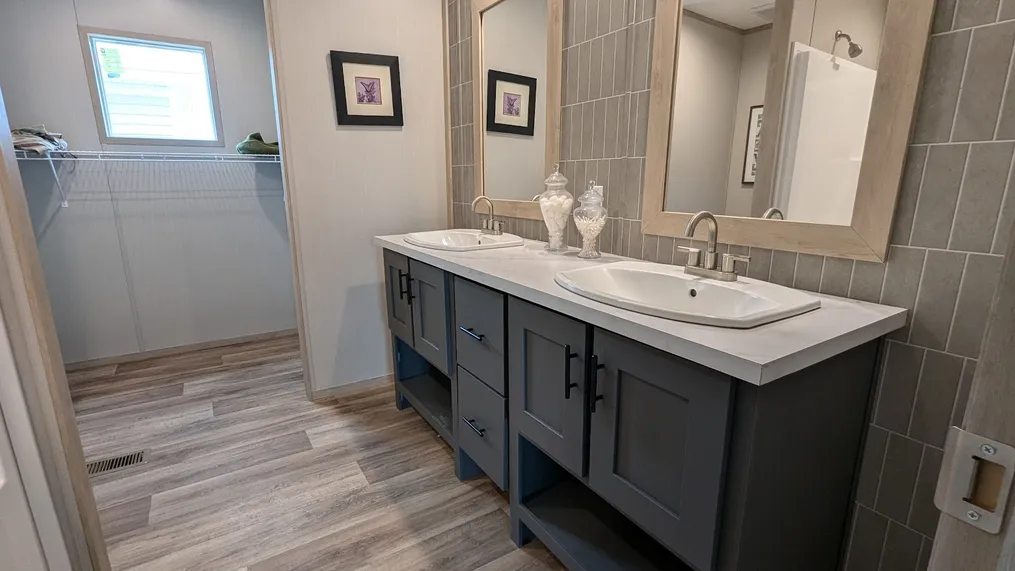 Double porcelain sinks and additional closet space in the primary bathroom