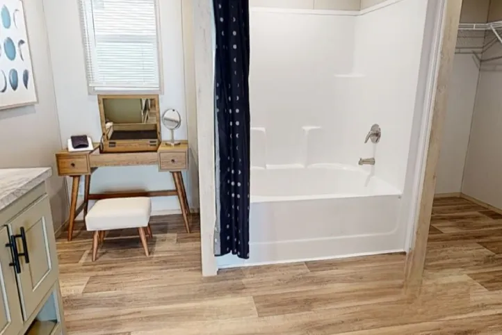 Vanity Space and Shower Tub Combo in Primary Restroom.