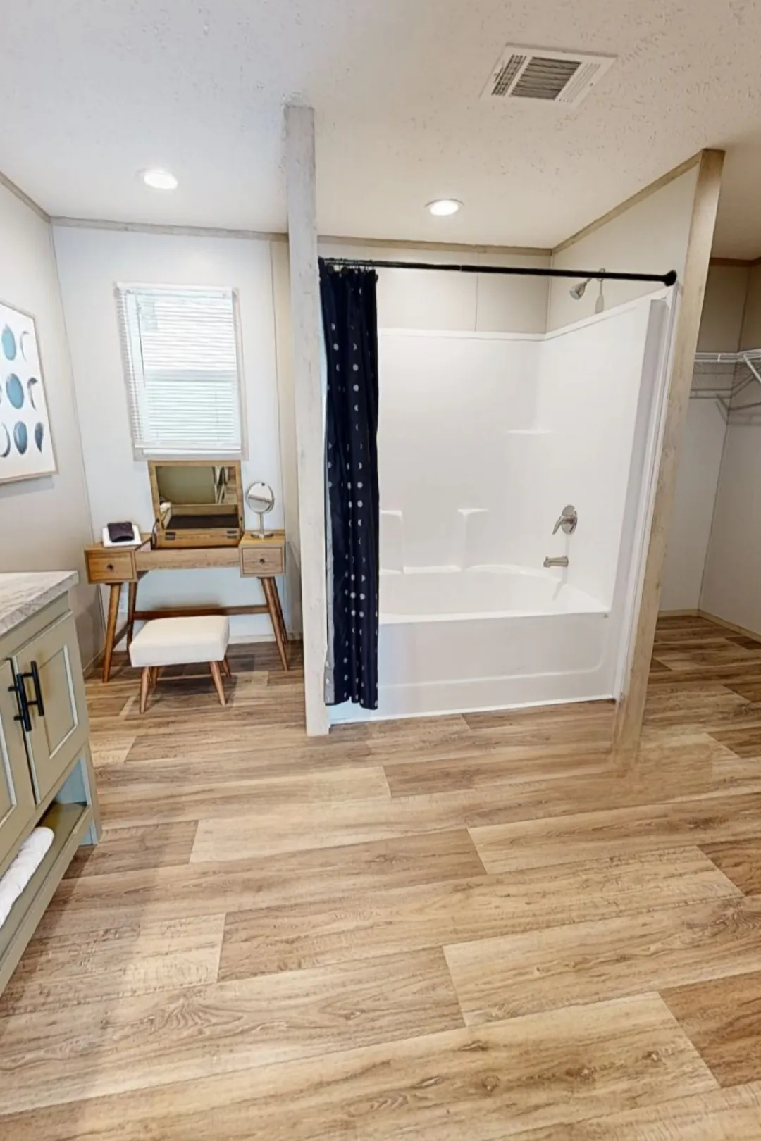 Vanity Space and Shower Tub Combo in Primary Restroom.