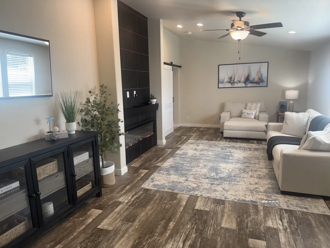 Large open space with an electric fireplace.