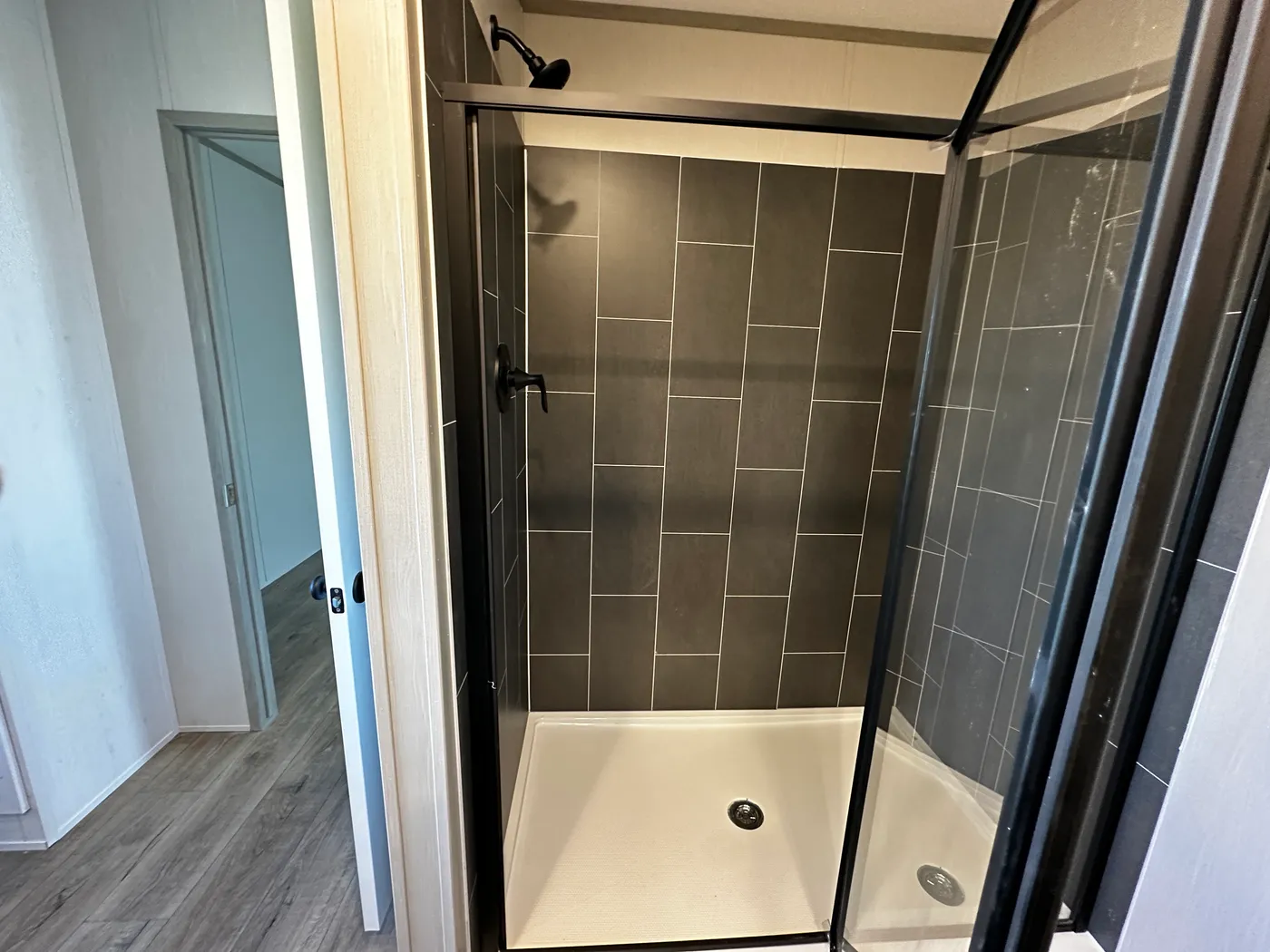 Discover this luxury porch model manufactured home featuring 2 bedrooms, 2 bathrooms, and high-end finishes designed for comfort and style. This modern manufactured home offers an open floor plan, stainless steel appliances, and a huge kitchen island perfect for entertaining. The spacious suite includes a walk-in closet and a large tiled low-profile walk-in shower for a spa-like feel. Built for durability and long-term value, this home features SmartPanel siding with a 50-year warranty, a 25-yea