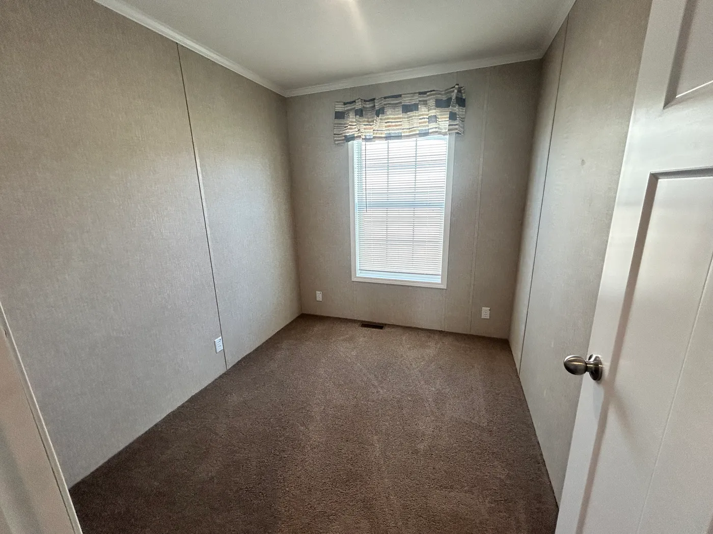 Guest bedroom with carpet throughout. 