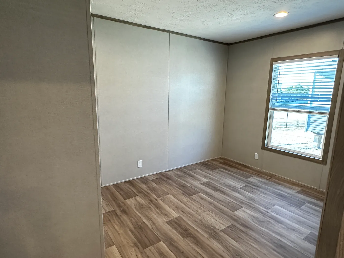 Modern luxury meets affordability in this 3 bedroom, 2 bathroom double wide manufactured home designed for comfort and style. The open-concept layout features a spacious living area with a gorgeous built-in entertainment center and plenty of natural light. The designer kitchen includes stainless steel appliances, a large kitchen island, and ample cabinet space, perfect for cooking and entertaining. Enjoy enhanced comfort with energy-efficient upflow ceiling vents for improved airflow throughout 