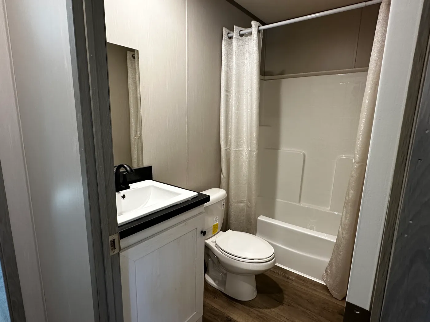 Discover this luxury porch model manufactured home featuring 2 bedrooms, 2 bathrooms, and high-end finishes designed for comfort and style. This modern manufactured home offers an open floor plan, stainless steel appliances, and a huge kitchen island perfect for entertaining. The spacious suite includes a walk-in closet and a large tiled low-profile walk-in shower for a spa-like feel. Built for durability and long-term value, this home features SmartPanel siding with a 50-year warranty, a 25-yea