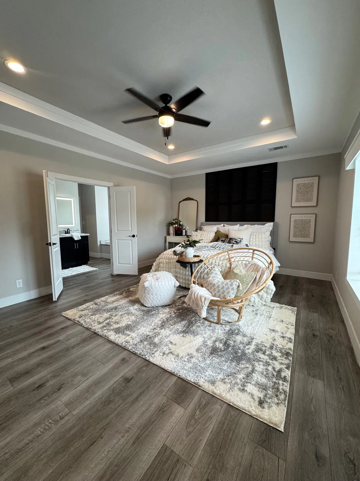 Large primary bedroom with tray ceiling 