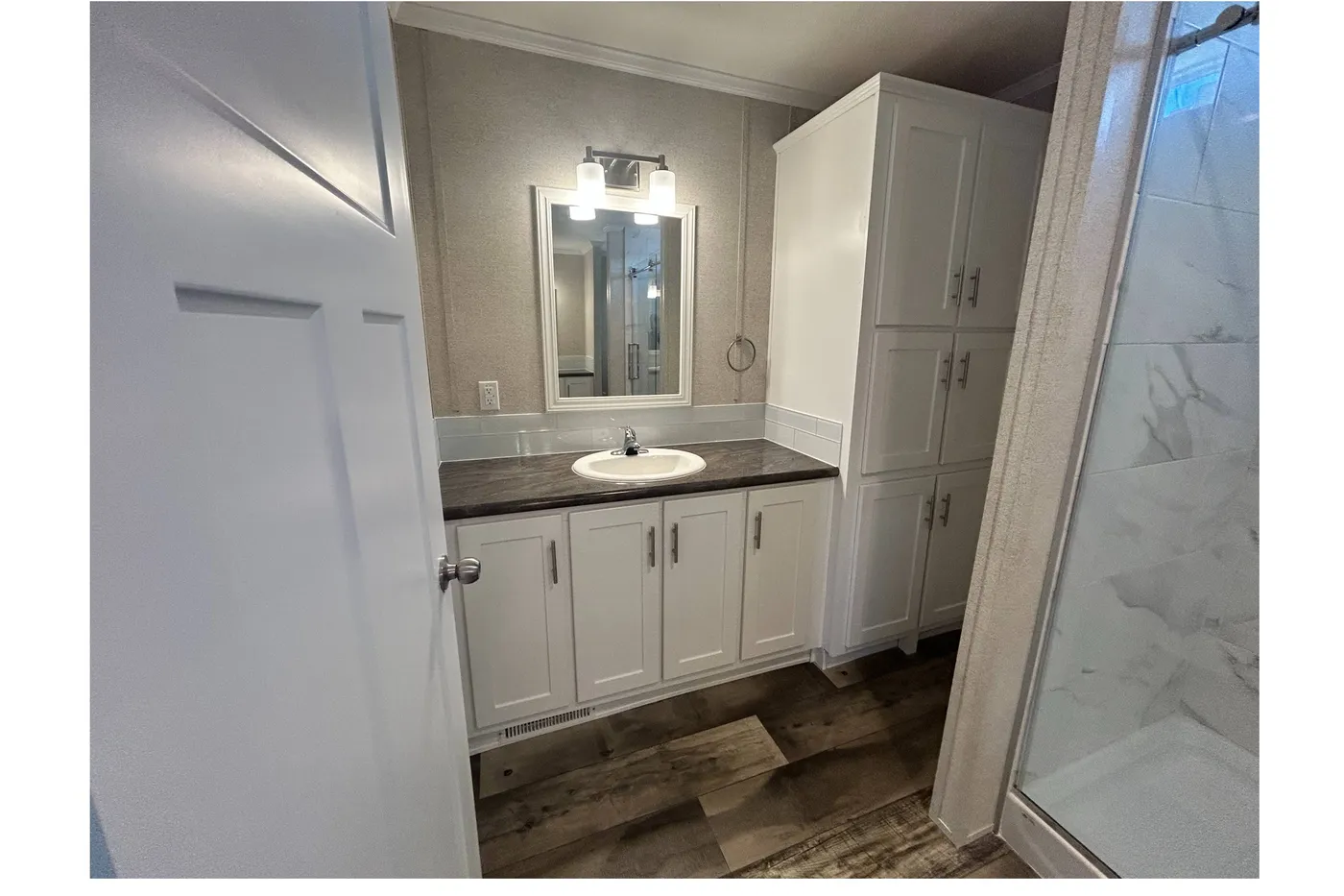 A look at the sink and storage located in the main bathroom. 