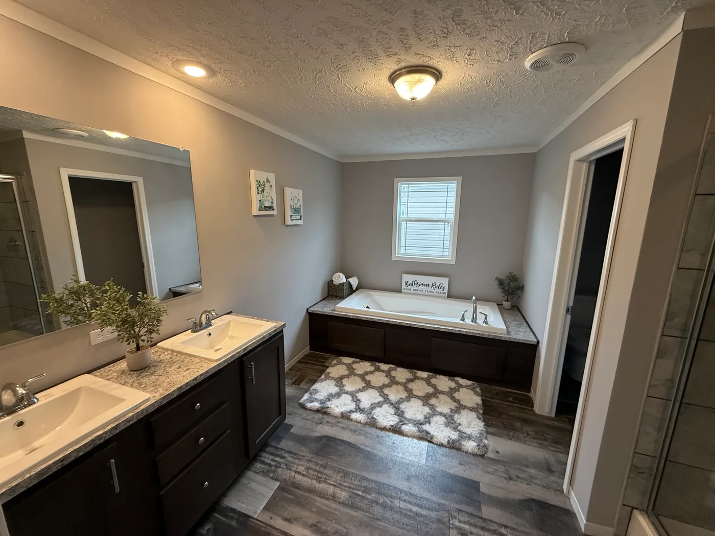 Spacious primary bathroom with soaking tub and ceramic shower