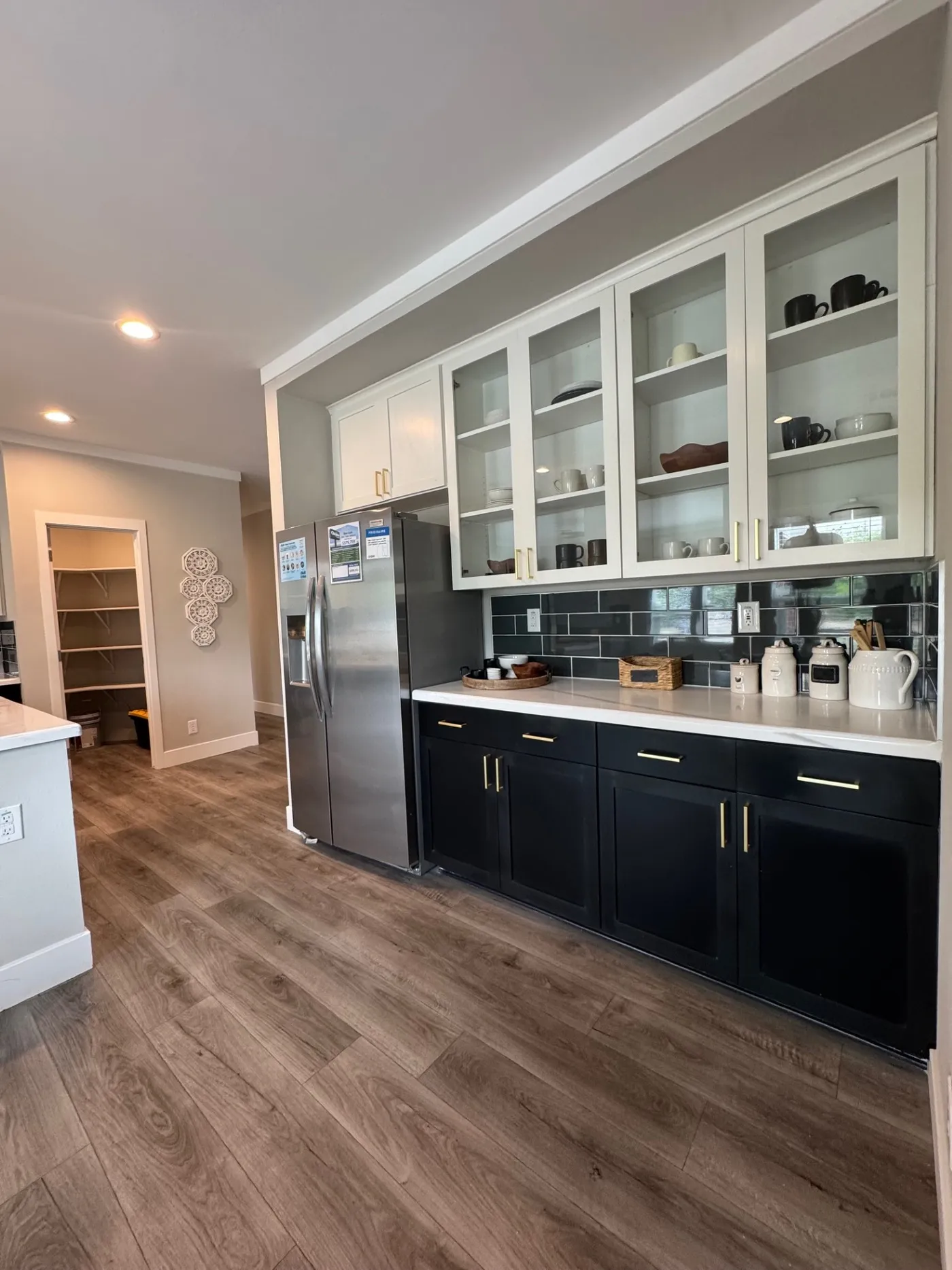Beautiful overhead glass cabinets and stainless steel side-by-side fridge