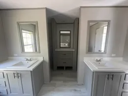 Separate vanities and his and hers closets off the on suite bathroom