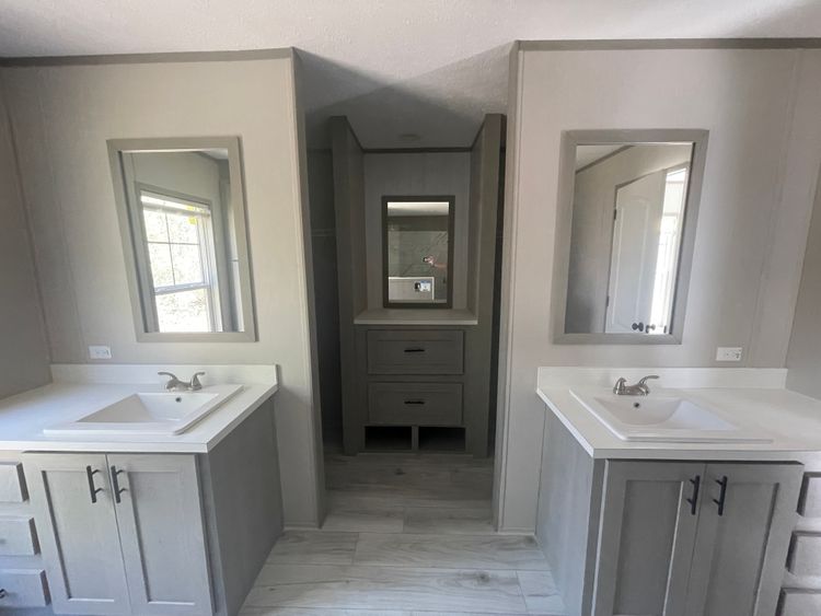 Separate vanities and his and hers closets off the on suite bathroom