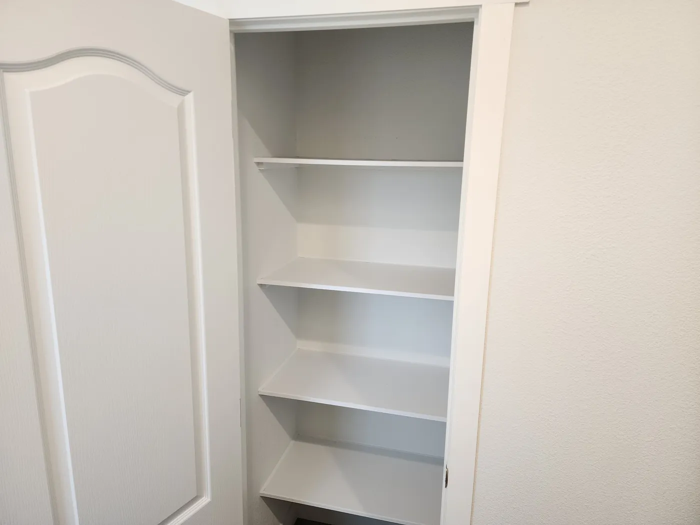 Linen cabinet in primary bathroom
