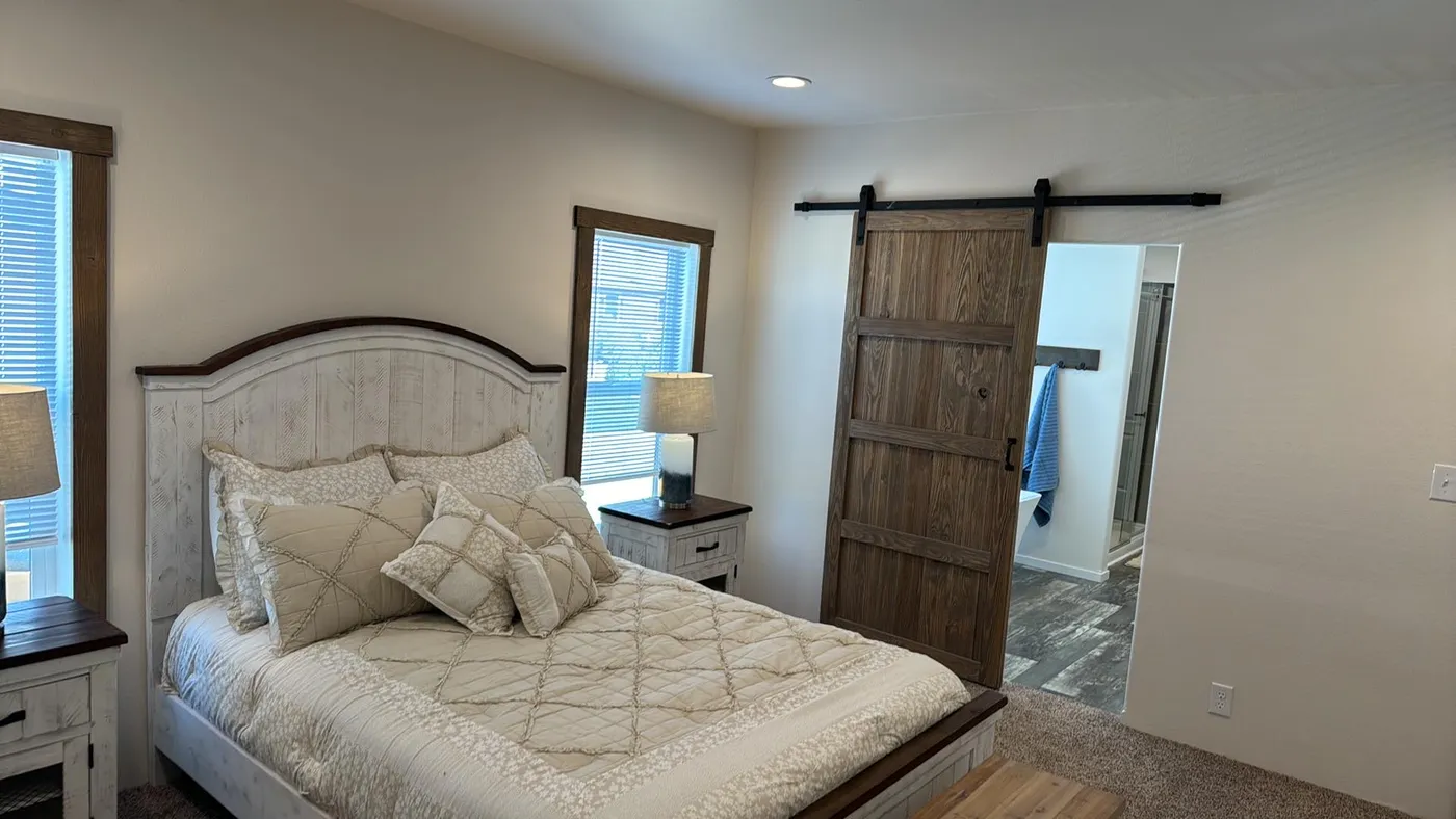 Sliding barn door to the primary bathroom.
