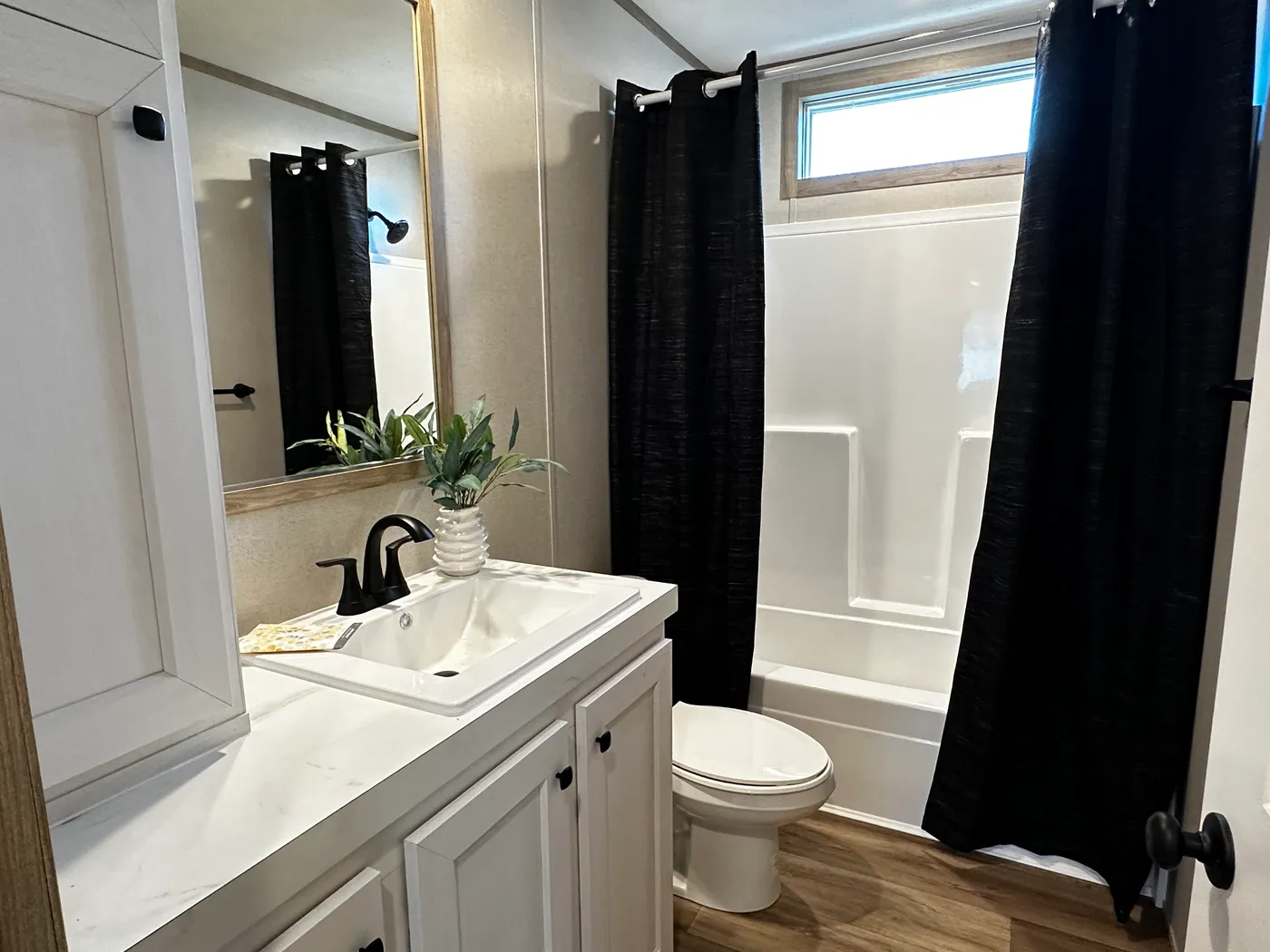 Modern luxury meets affordability in this 3 bedroom, 2 bathroom double wide manufactured home designed for comfort and style. The open-concept layout features a spacious living area with a gorgeous built-in entertainment center and plenty of natural light. The designer kitchen includes stainless steel appliances, a large kitchen island, and ample cabinet space, perfect for cooking and entertaining. Enjoy enhanced comfort with energy-efficient upflow ceiling vents for improved airflow throughout 