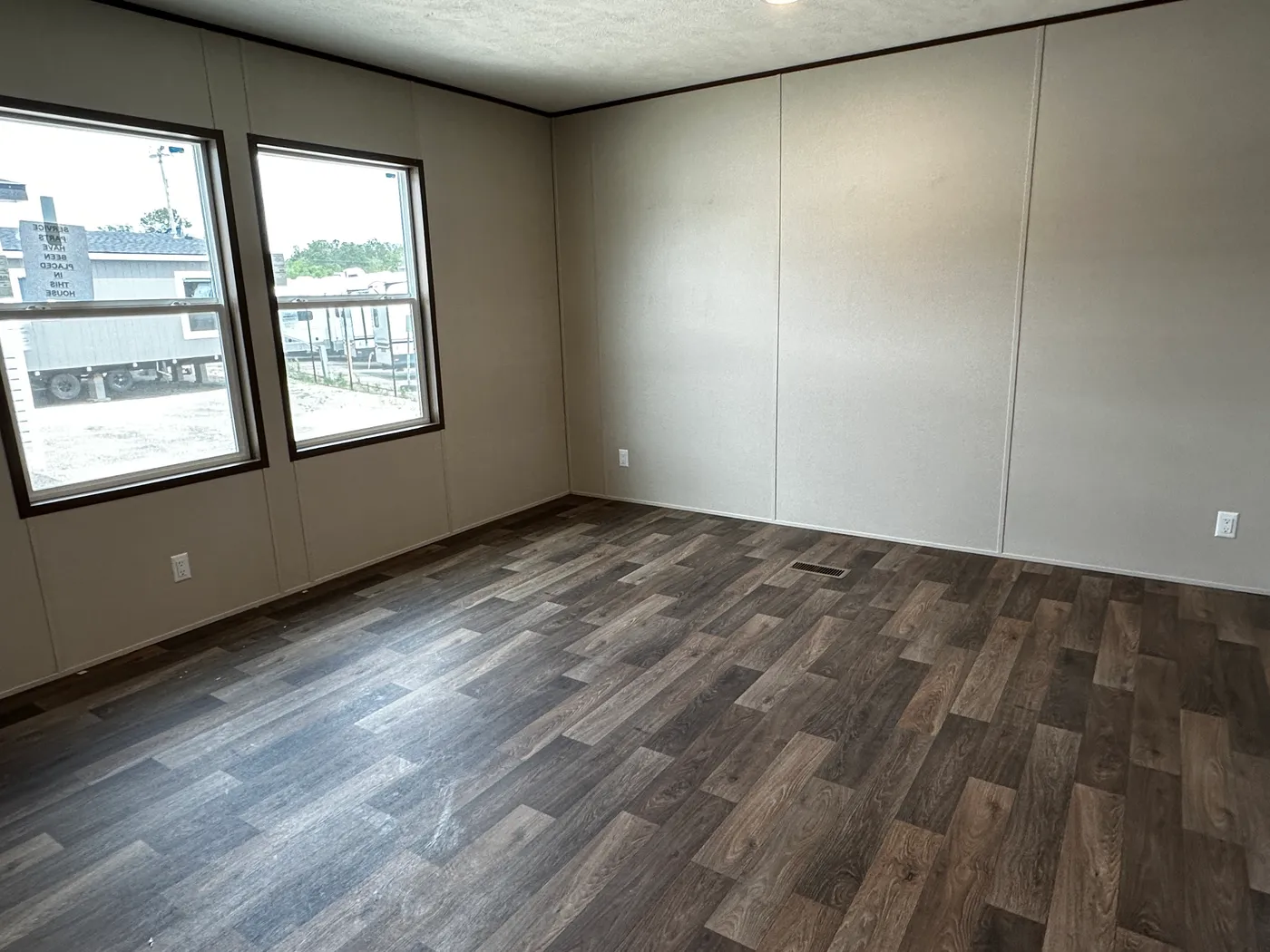 Discover the most affordable and spacious 4 bedroom, 2 bath doublewide manufactured home on the market! This budget-friendly mobile home features elevated ceilings, an open-concept layout, and plenty of room to grow with both a living room and separate den—perfect for entertaining, relaxing, or family space. The modern kitchen includes a large center island with ample storage and workspace. The private primary suite offers a walk-in closet, plus a luxury separate soaking tub and walk-in shower f