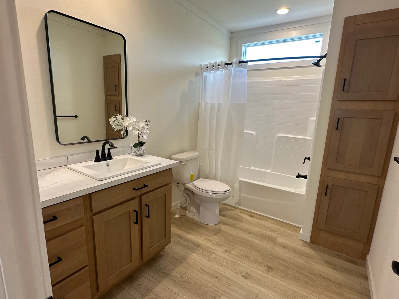 Discover The Cambridge, a stunning 3-bedroom, 2-bath luxury manufactured home at Clayton Homes of Alvin, Texas! This beautiful home features tape-and-textured walls, elegant crown molding, gorgeous quartz countertops, and a Samsung Smart Refrigerator. The gourmet kitchen includes a hidden walk-in Butler’s pantry with extra shelving and a second refrigerator for exceptional storage. The luxurious primary bedroom showcases a beautiful illuminated accent wall, while the spa-inspired primary bathroo