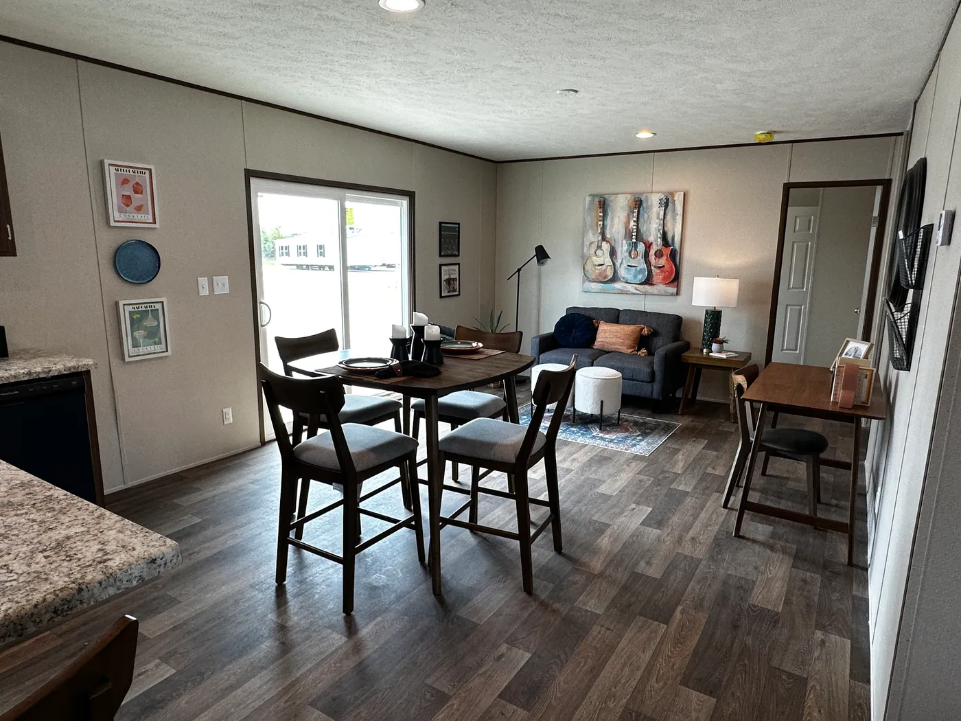 Discover the most affordable and spacious 4 bedroom, 2 bath doublewide manufactured home on the market! This budget-friendly mobile home features elevated ceilings, an open-concept layout, and plenty of room to grow with both a living room and separate den—perfect for entertaining, relaxing, or family space. The modern kitchen includes a large center island with ample storage and workspace. The private primary suite offers a walk-in closet, plus a luxury separate soaking tub and walk-in shower f