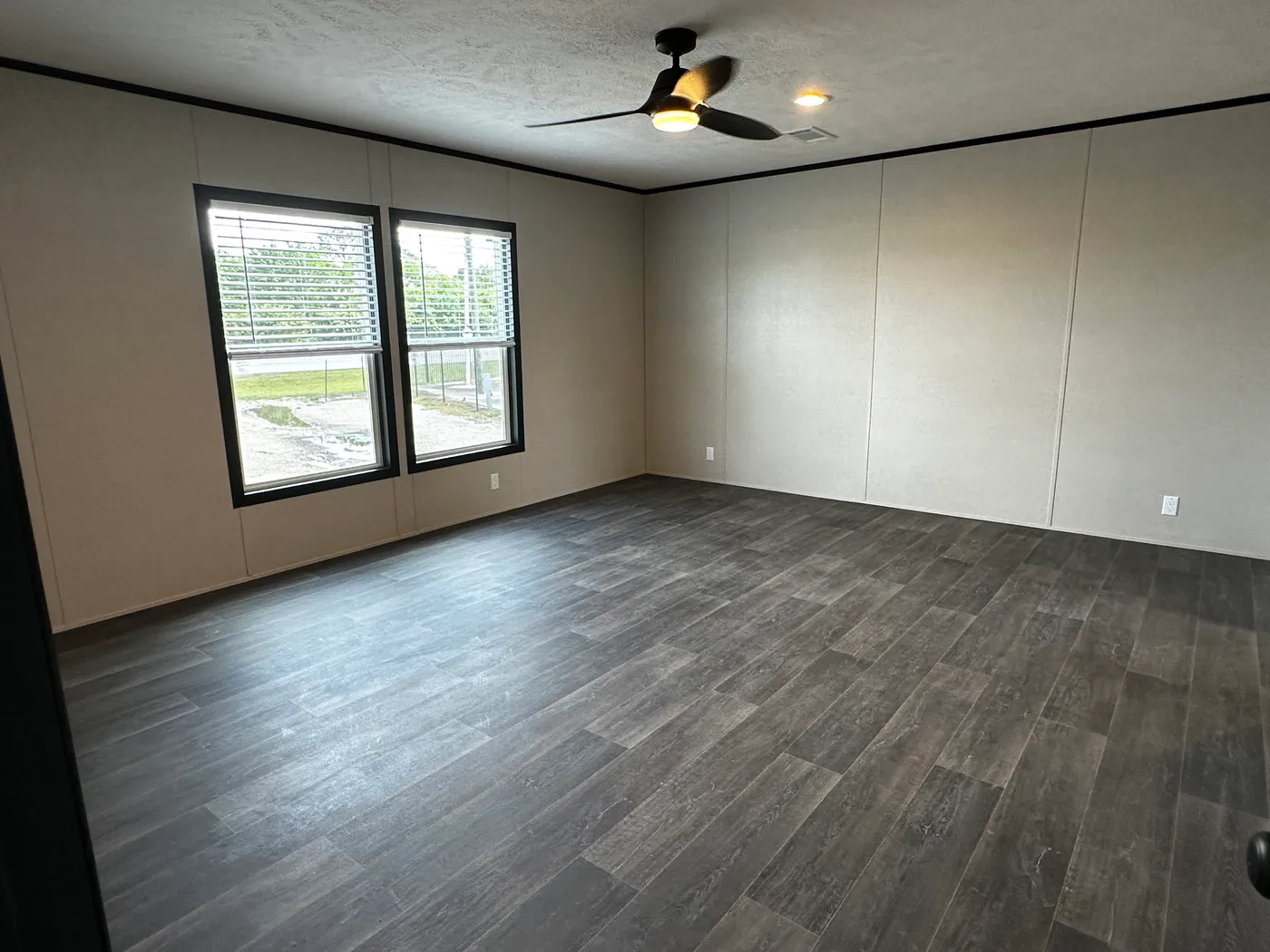 Spacious 4 bedroom 2 bath double wide manufactured home with massive square footage and modern design. Features an open floor plan with a large living room and separate den, perfect for entertaining or family living. The master suite offers a relaxing garden soaking tub, tiled-in walk-in shower, and plenty of space. Enjoy a cozy built-in fireplace, stylish finishes, and energy-efficient construction. This affordable mobile home is ideal for families seeking space, comfort, and value.
