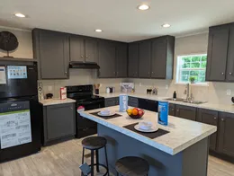 Expansive, light-filled kitchen offers ample counter space, and island