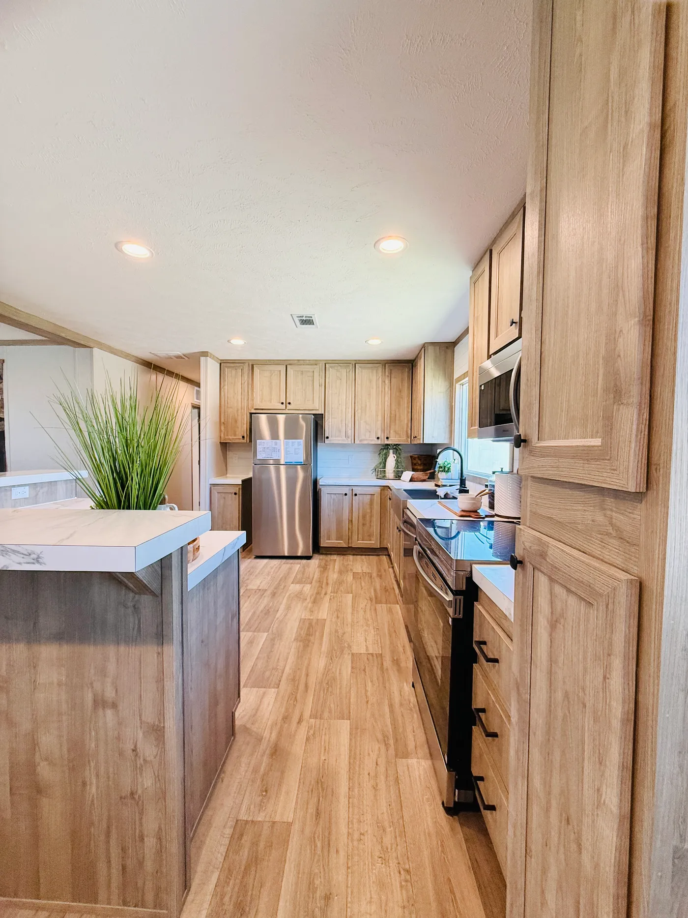 his beautiful open-concept kitchen features warm cabinetry, modern appliances, and a spacious center island perfect for meal prep, casual dining, or gathering with family and friends.

The layout flows seamlessly into the dining and living areas, making it the heart of the home and ideal for hosting or enjoying everyday moments.