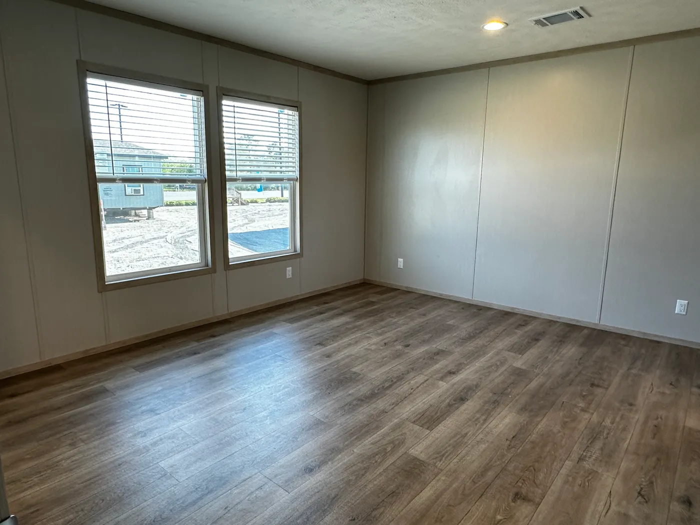 Spacious 3 bedroom, 2 bathroom double wide manufactured home built for comfort and family living. This open layout features both a living room and separate den, perfect for movie nights, entertaining, or creating private space for kids and adults. The modern kitchen includes stainless steel appliances and ample cabinet space. Enjoy year-round comfort with energy-efficient upflow ceiling vents for improved airflow. The private primary suite offers a relaxing retreat with a large soaking tub and s